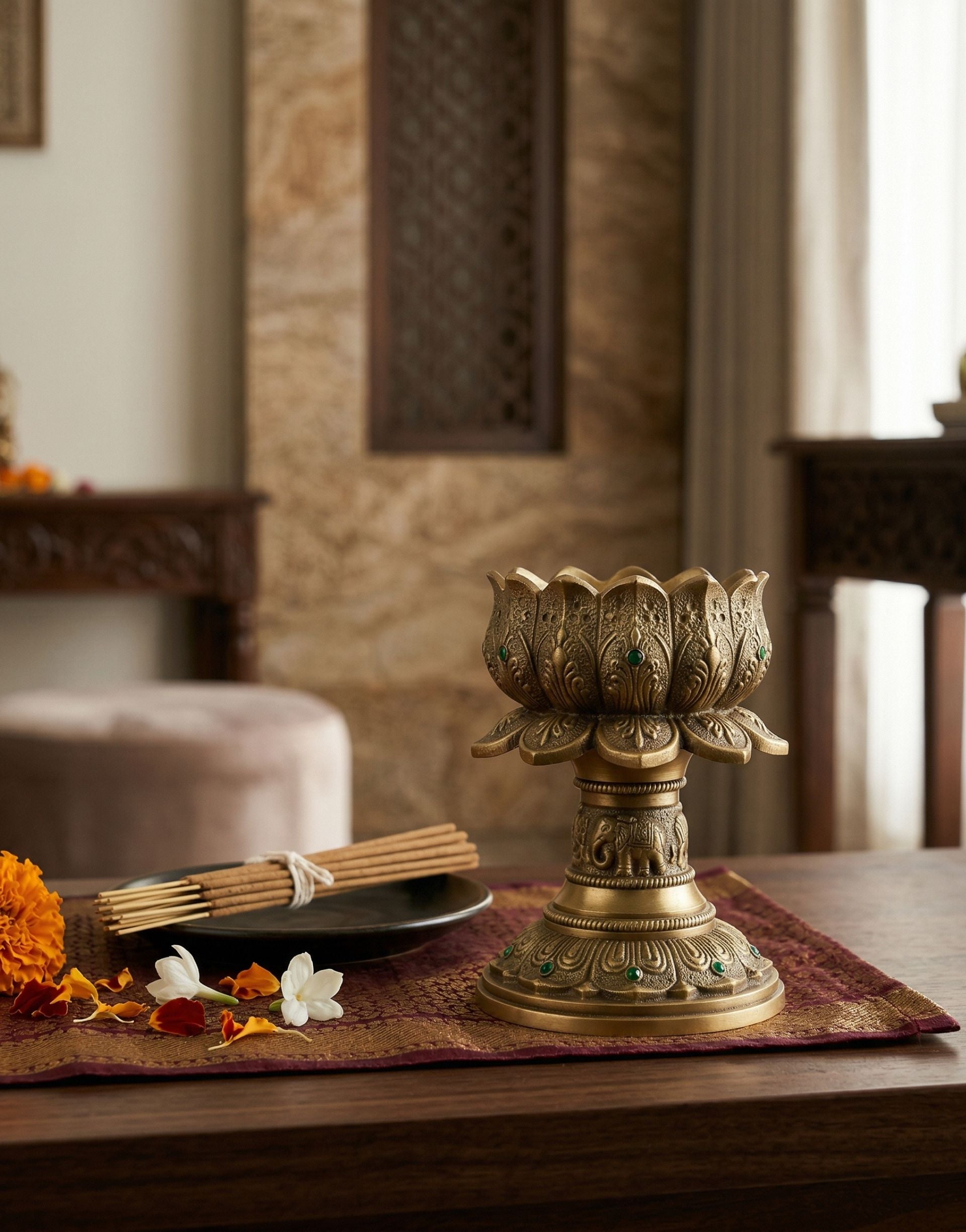Decorative brass lotus camphor holder on a table with a blurred background