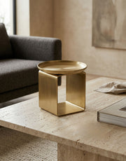 Brass candle holder on a coffee table in a living room setting